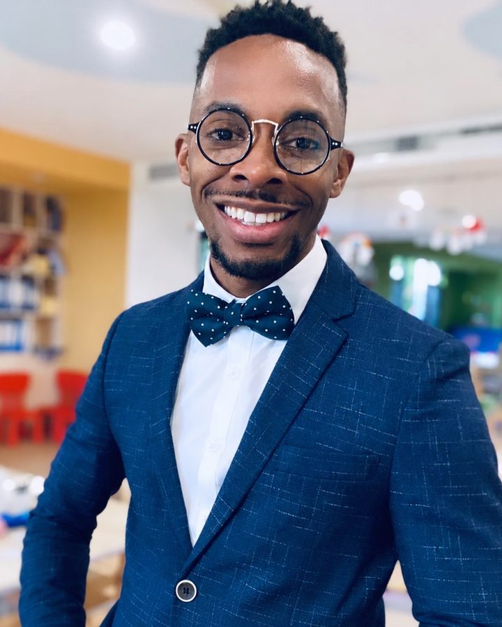 Raheem Harvey, founder of Brave Hands, smiling in a navy blazer and polka-dot bow tie